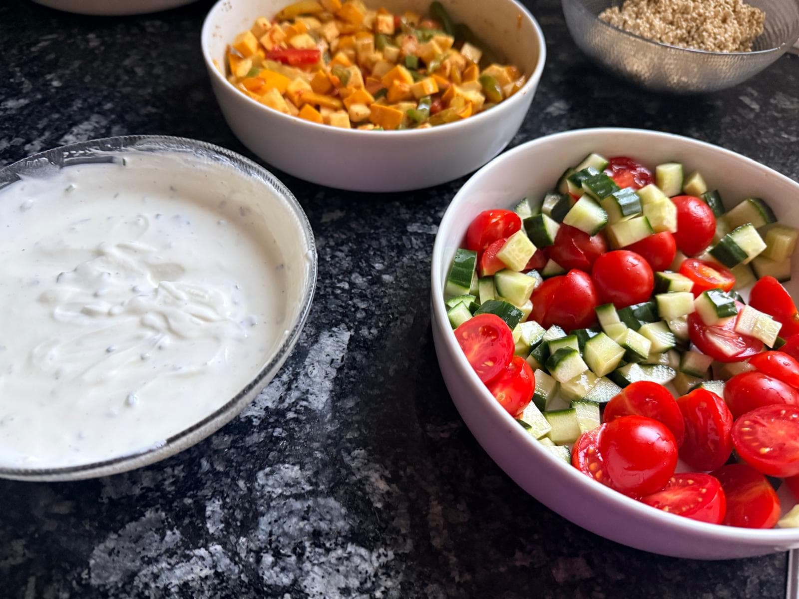 Frische Lebensmittel mit Tomaten-Gurken-Salat, Kräuterquark und Gemüse